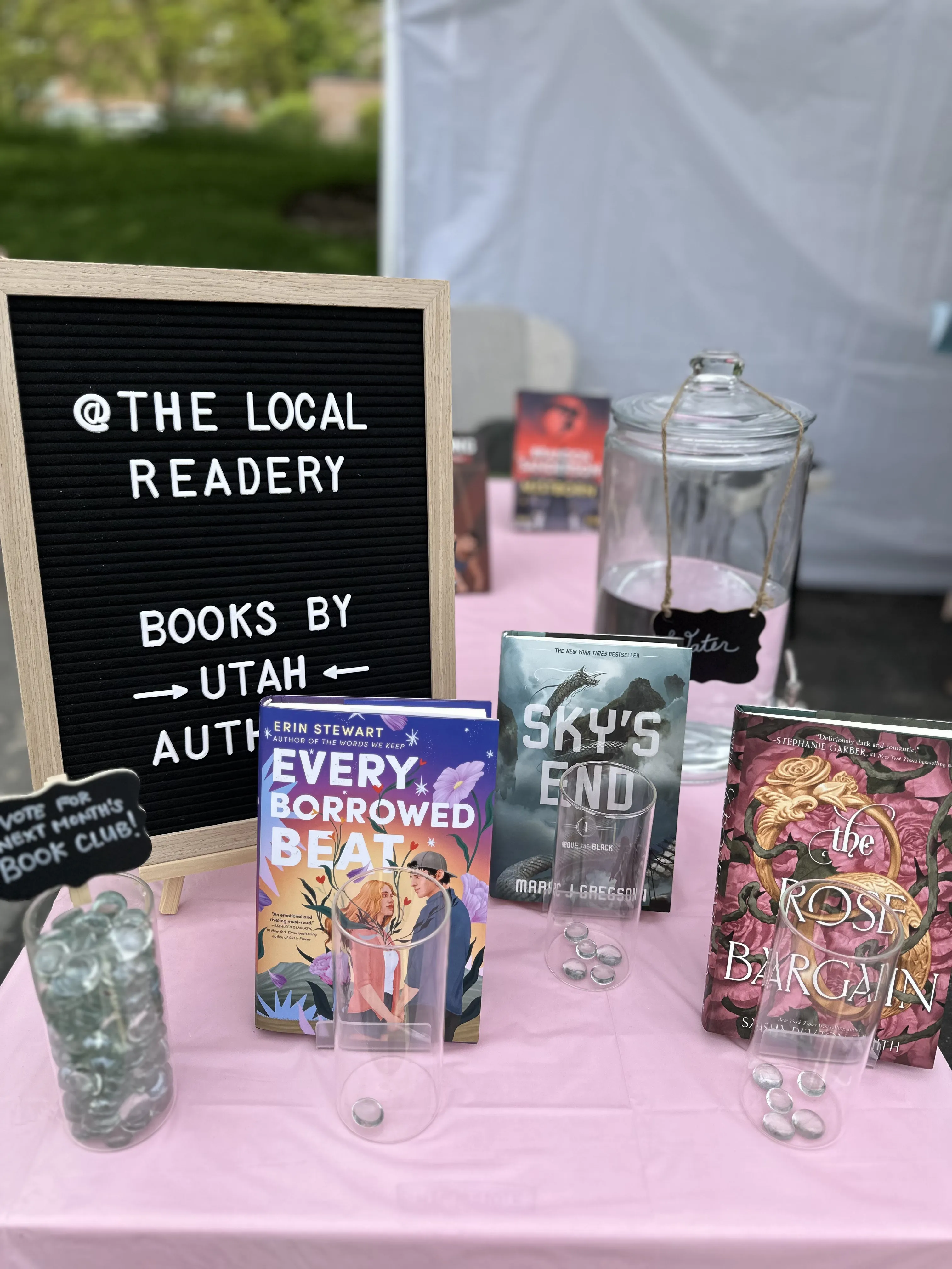 Letter board and books by Utah authors on The Local Readery market table